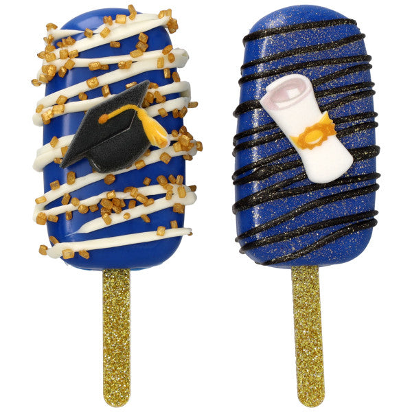 Two blue cakesicles with gold glitter sticks, decorated with drizzle and sprinkles, topped with pressed sugar graduation cap and diploma scroll accents.