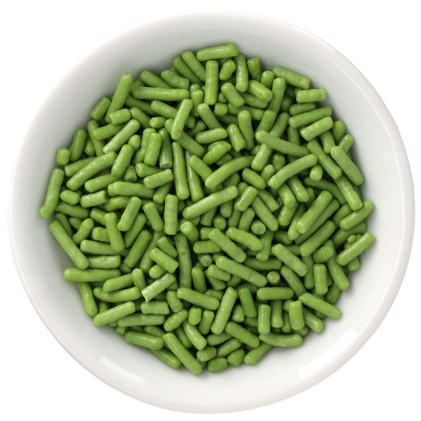 White bowl filled with grassy green Natural Dyed Made Simply™ rod-shaped sprinkles, shown from above against a clean white background.