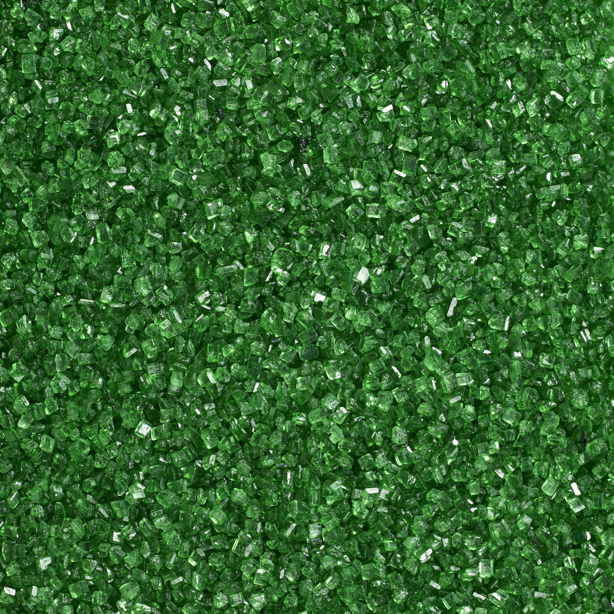 Close-up texture of dark green sanding sugar showing coarse, translucent green sugar crystals with sparkling, faceted surfaces.