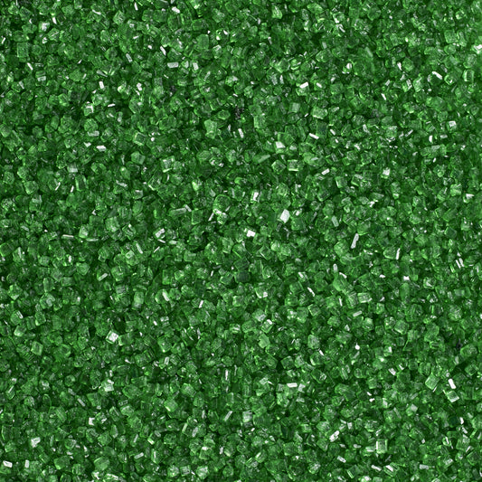 Close-up texture of dark green sanding sugar showing coarse, translucent green sugar crystals with sparkling, faceted surfaces.