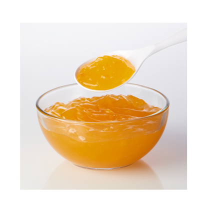 Bowl of golden peach filling with a spoonful being lifted, showcasing its smooth and fruity texture.