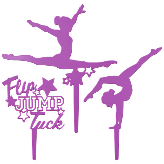 Three-piece purple gymnastics cake topper set featuring two gymnast silhouettes and a "Flip Jump Tuck" pick.