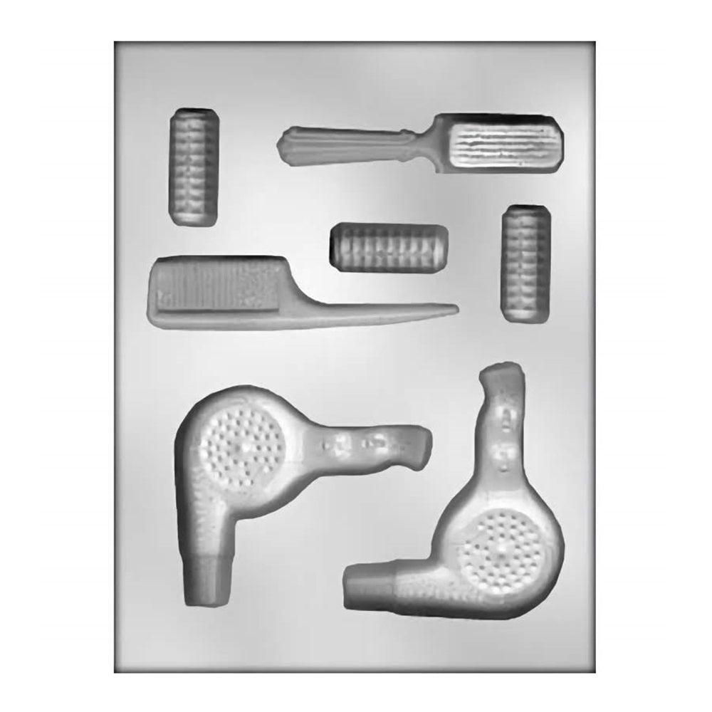 Chocolate mold tailored for hair stylists, displaying a variety of hairdressing tools. It includes cavities shaped like a hair dryer, scissors, comb, and hairbrush. The mold enables the creation of themed chocolates that resemble salon equipment, ideal for gifts or celebration favors for hair professionals.