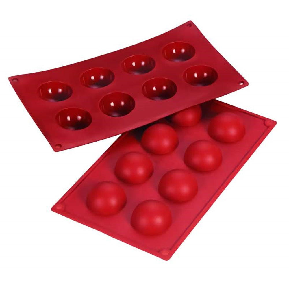 The image features two red silicone molds with half-sphere cavities, suitable for making spherical chocolate treats or desserts. Each mold has eight cavities and is set against a white background.