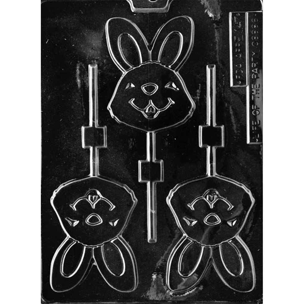Clear plastic chocolate lollipop mold with three bunny face cavities featuring tall upright ears, inner-ear outlines, a rounded nose, and a smiling mouth with a small tooth, plus stick channels.