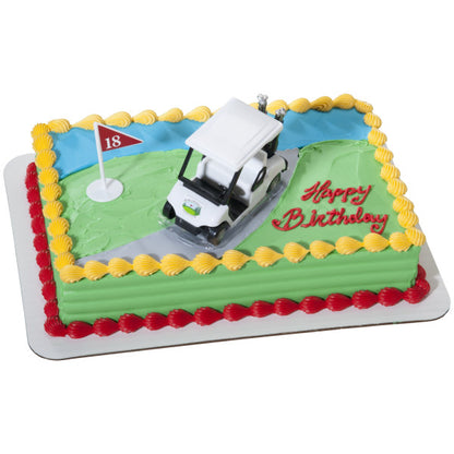 A green golf course-themed sheet cake decorated with a golf cart topper and an 18th-hole flag.