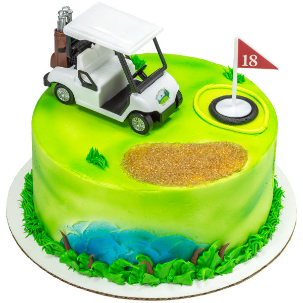 A round cake designed as a golf course, featuring a golf cart topper, an 18th-hole flag, a sand trap, and a pond.