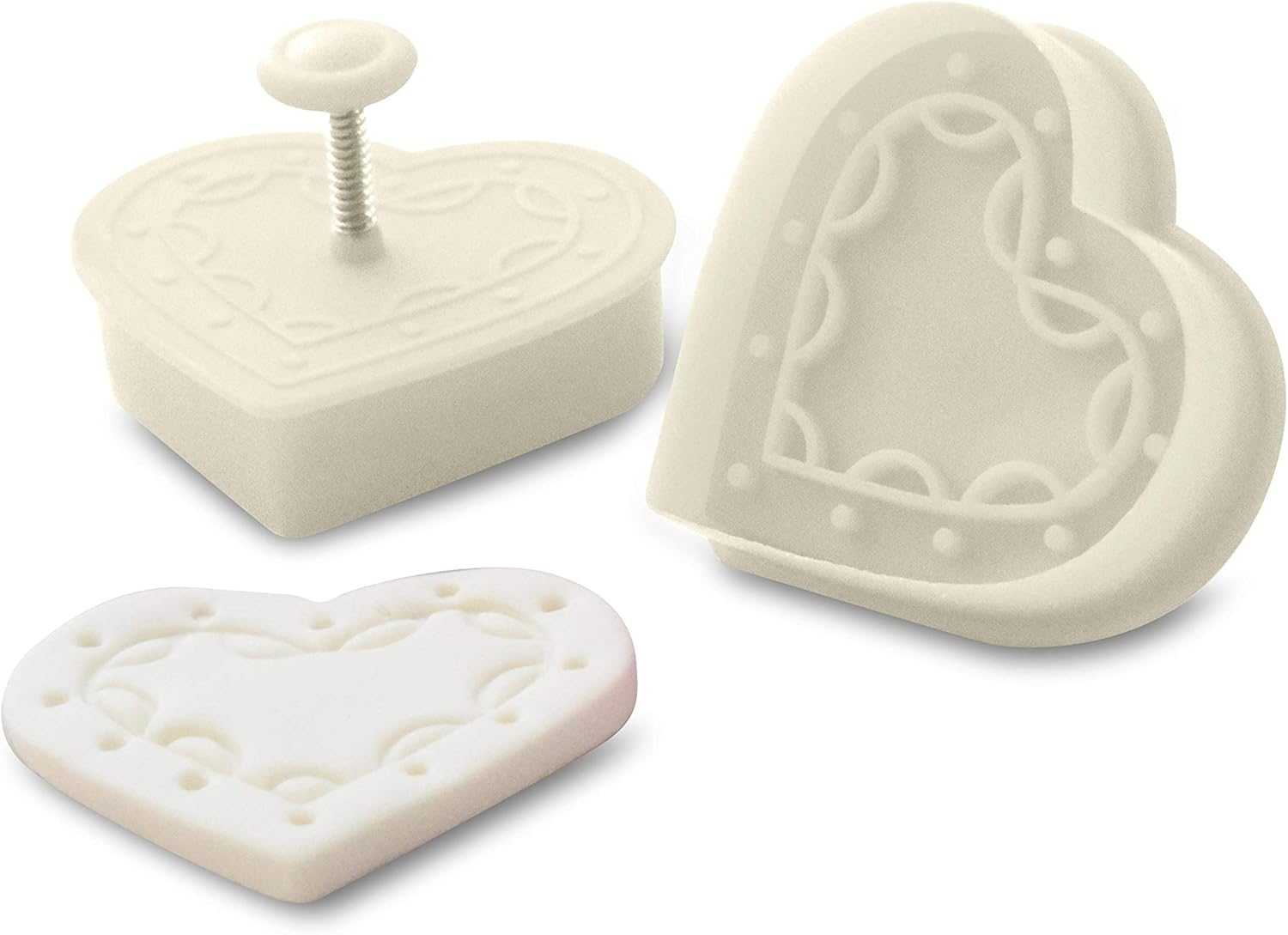 Close-up of a heart plunger cutter with an imprinted fondant heart featuring intricate patterns.