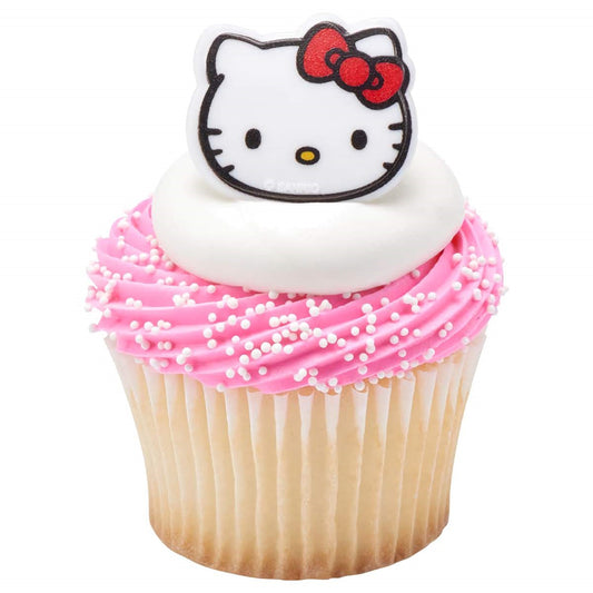 Hello Kitty cupcake toppers with the beloved character's face, featuring her signature bow, on a background of pink frosting sprinkled with white pearls, a cute addition to any party from Lynn's Cake, Candy, and Chocolate Supplies.