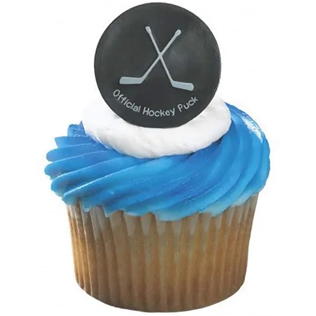 Cupcake with blue frosting topped with a black hockey puck ring featuring crossed hockey sticks and small “Official Hockey Puck” text on the front.