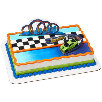 A race-themed sheet cake with a checkered flag design, an orange border, and a Hot Wheels car on a track topper.