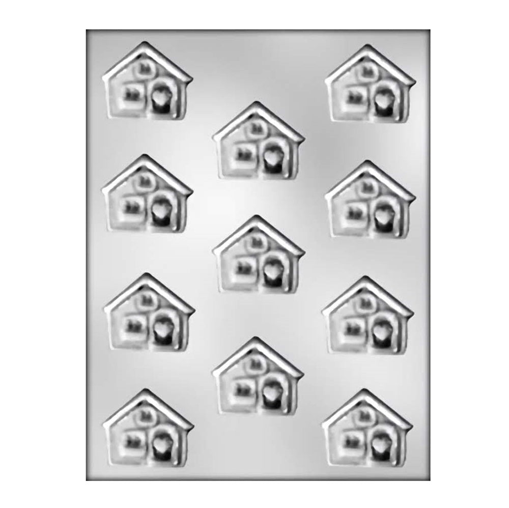 This image displays a chocolate mold featuring eleven cavities, each shaped like a quaint house with a heart in the center. The houses have a charming design with details resembling windows, a door, and a roof, evoking a cozy and inviting appearance. 