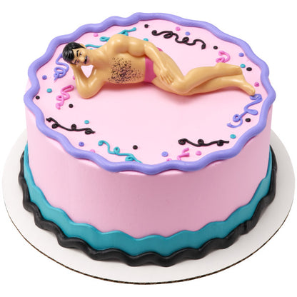 A pink and blue cake with playful confetti decorations, topped with the Hunky Man figurine for a fun and festive touch.