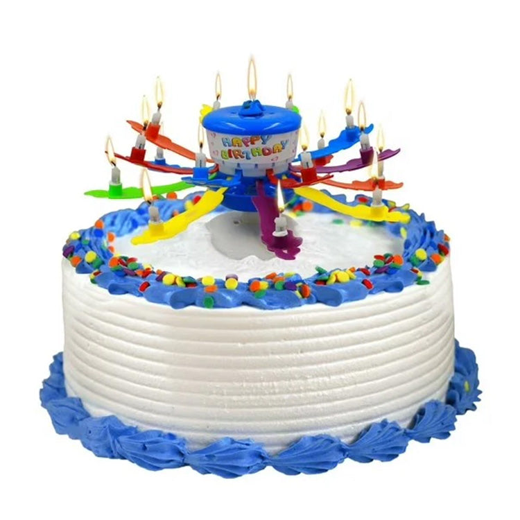 The Incredible Candle opened on a frosted cake, with colorful arms spread out, multiple small flames lit around the top, and a blue center hub.