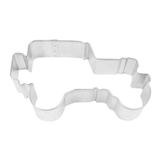 Military truck-shaped cookie cutter with detailed rugged edges, photographed from a top-down angle.