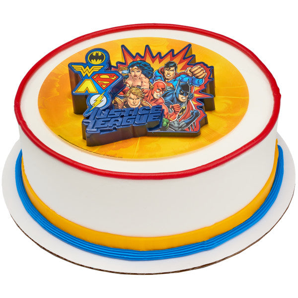 A round cake decorated with red, yellow, and blue accents, topped with the illuminated Justice League™ cake topper.