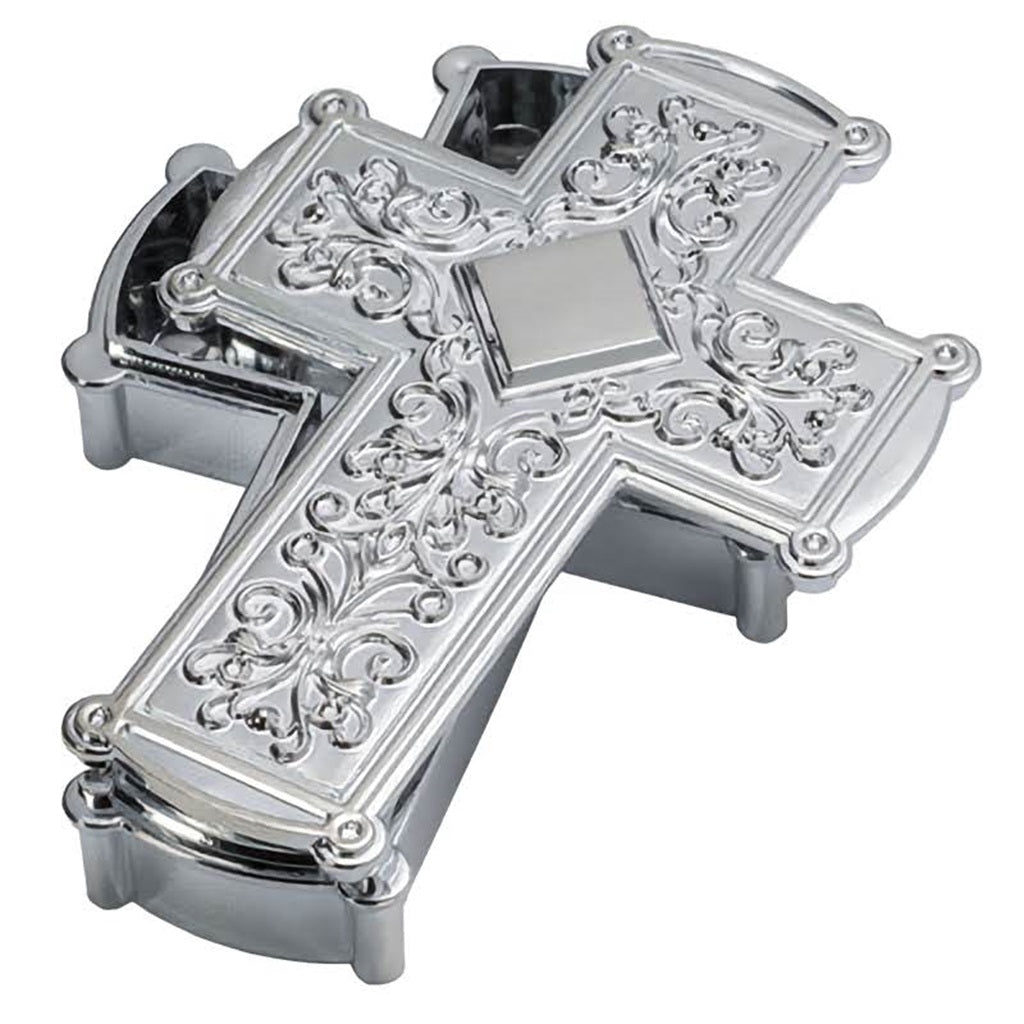 Silver cross keepsake cake topper shaped like a cross with raised scrolling panels and a hinged box-style base, photographed on a white background.