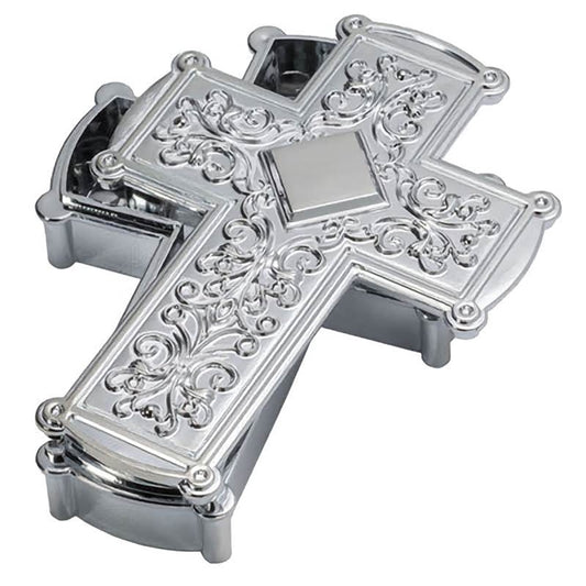 Silver cross keepsake cake topper shaped like a cross with raised scrolling panels and a hinged box-style base, photographed on a white background.