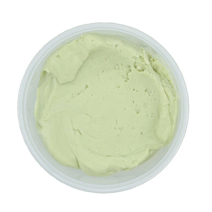 Top-down view of a smooth, creamy key lime candy center in a clear plastic container.