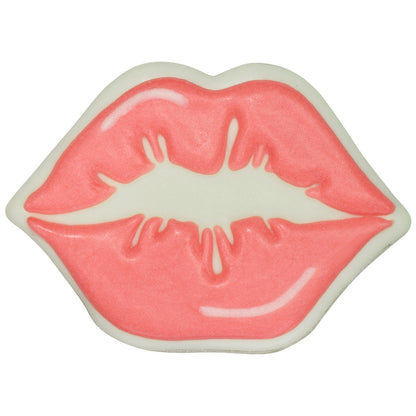 Decorated kissing lips cookie with soft pink icing, white outline, and curved white highlight accents on a white background.