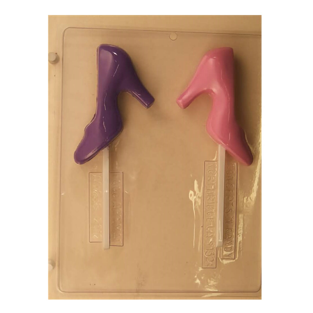 Chocolate mold for creating ladies' high-heeled shoe suckers, featuring two cavities for candy creation. One cavity displays a smooth, elegant high-heel design, while the second cavity shows the same style with a glossy finish. Both are attached to sturdy sticks for easy handling and are set against a durable mold base, ready to be filled with your choice of chocolate or candy melt for stylish, edible treats.