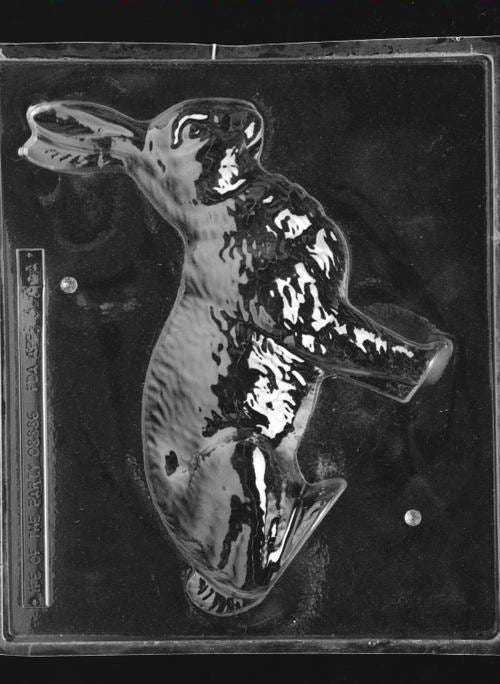 Clear plastic chocolate mold showing the front half of a large bunny figure in profile with raised fur texture and defined ears, designed for a 3D chocolate bunny.