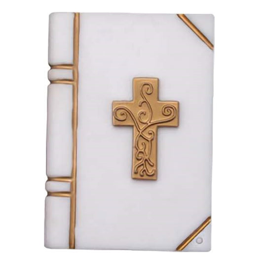 Image of a large Bible cake topper with a white book design and raised gold cross in the center, featuring embossed detailing.

