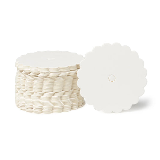 Stack of glossy white scalloped-edge cake pop boards, 2 11/16 inches in diameter, with one board facing forward showing the center hole and clean finish.