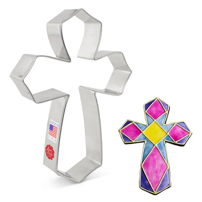 Cross cookie cutter alongside a colorful stained-glass-inspired decorated cookie.