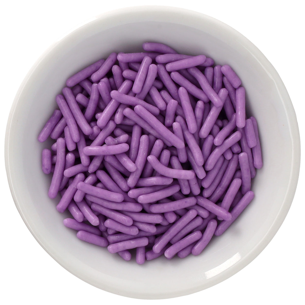 White bowl filled with soft lavender purple Natural Dyed Made Simply™ rod-shaped sprinkles, shown in a close-up overhead view on a white background.