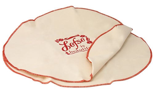 Set of two 21-inch cotton lefse cozies, one printed with “Lefse is Beautiful” and red trim, used to keep lefse soft and fresh after cooking.