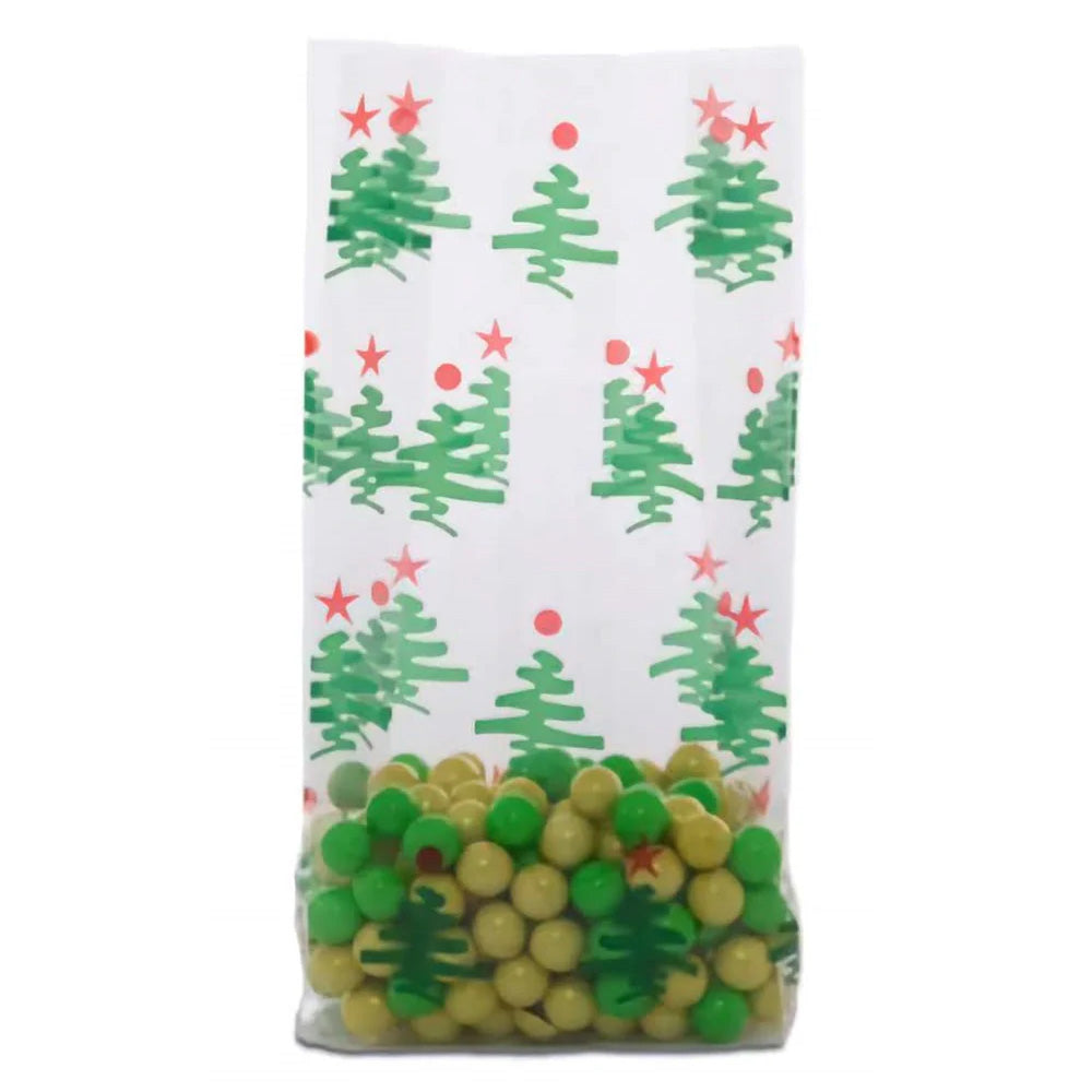 Medium clear cello treat bag with a white background printed with green Christmas trees and red star toppers, shown standing with a gusseted bottom and filled with green and gold candy pieces.