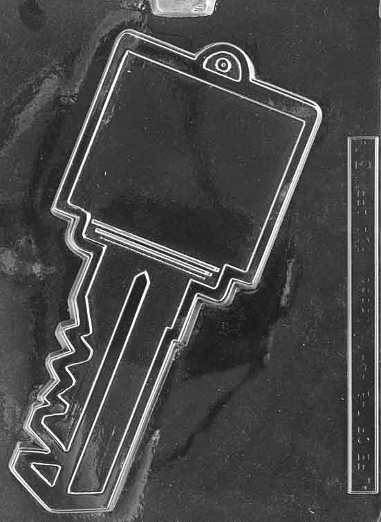 Chocolate mold M030 Key with oversized key shape including handle and teeth details for symbolic chocolate treats.