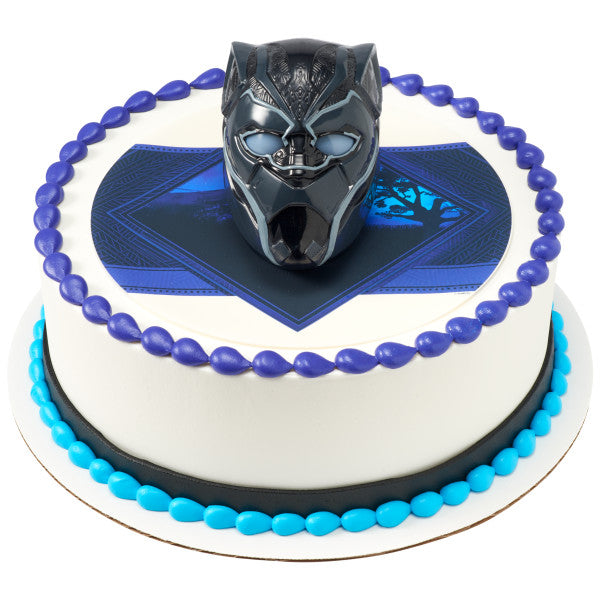 A round cake with a Black Panther-themed edible image, bordered in blue and black frosting, with the Black Panther Light-Up DecoSet as the centerpiece.