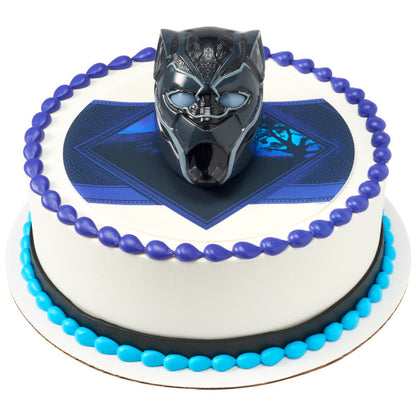 A round cake with a Black Panther-themed edible image, bordered in blue and black frosting, with the Black Panther Light-Up DecoSet as the centerpiece.