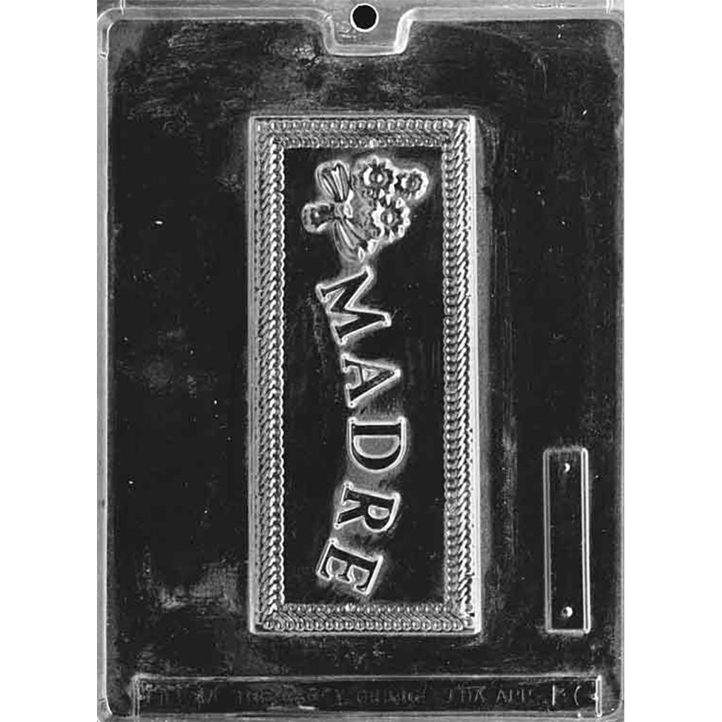 Clear plastic chocolate bar mold with a rectangular cavity featuring raised “MADRE” lettering and a small bouquet design, shown on a dark background.