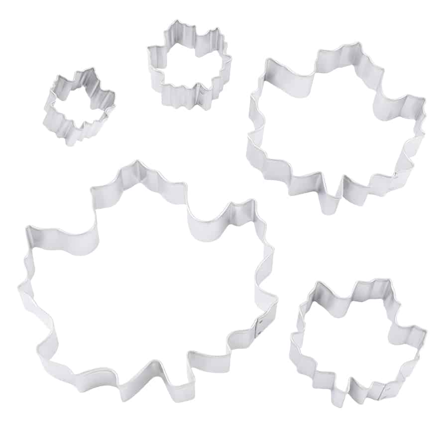 Five maple leaf cookie cutters in various sizes arranged on a white background, showing their detailed edges.