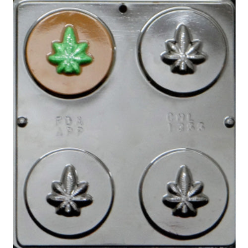 Marijuana leaf chocolate mold featuring four cavities with round discs embossed with marijuana leaf designs.