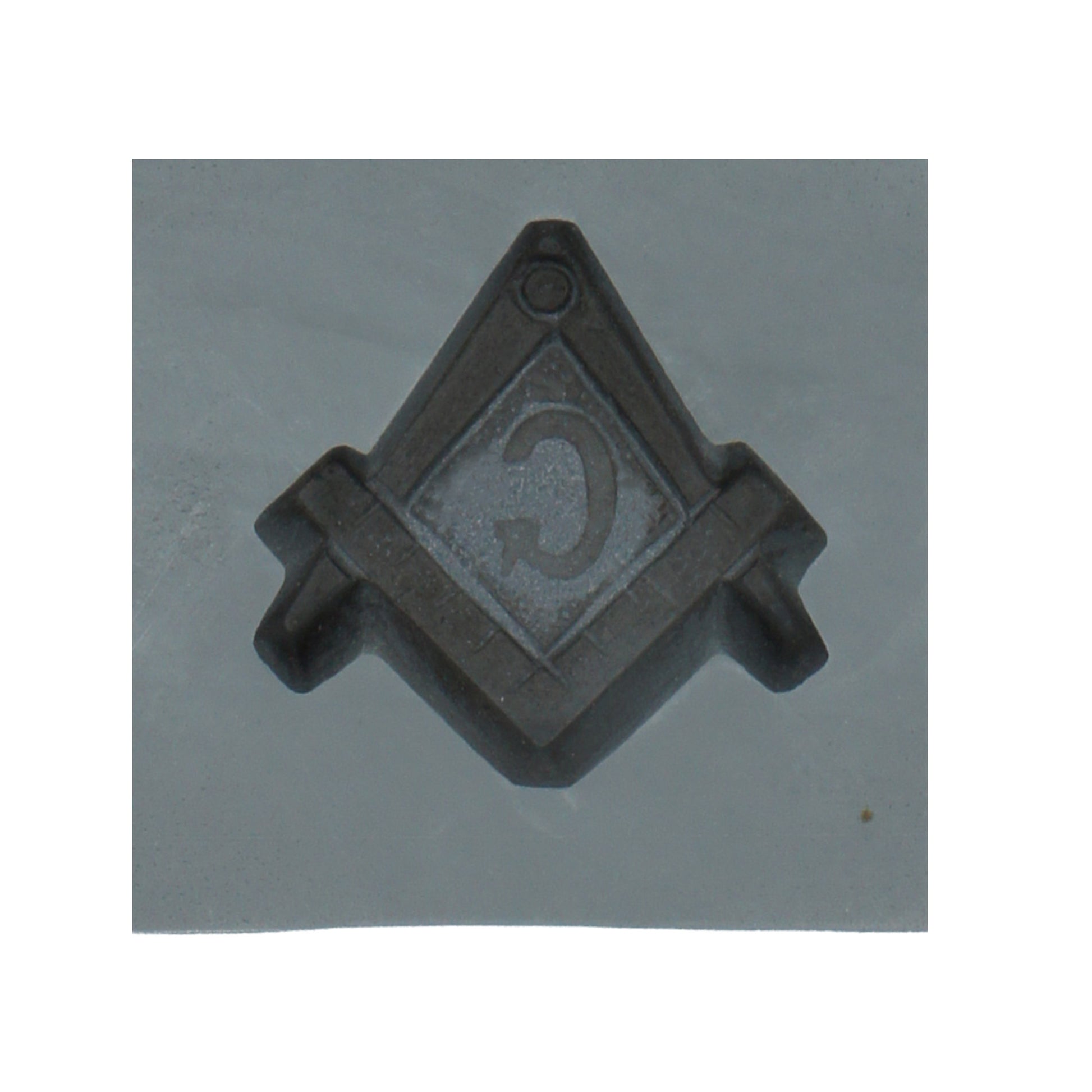 Close-up of a single cavity in the Masonic compass and square rubber mint mold, showcasing the detailed Masonic symbol for candy making.