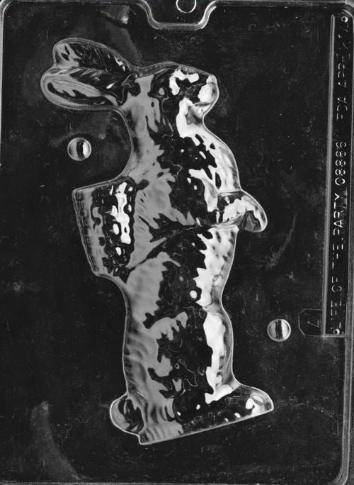 Clear plastic chocolate mold showing one half of an upright bunny figure with a basket strapped to its back, designed to form a 3D chocolate bunny.