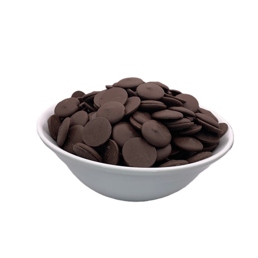 Frontal view of a bowl of Merckens Coco Dark chocolate melting wafers, with a focus on the deep brown color and glossy finish of these premium baking essentials.