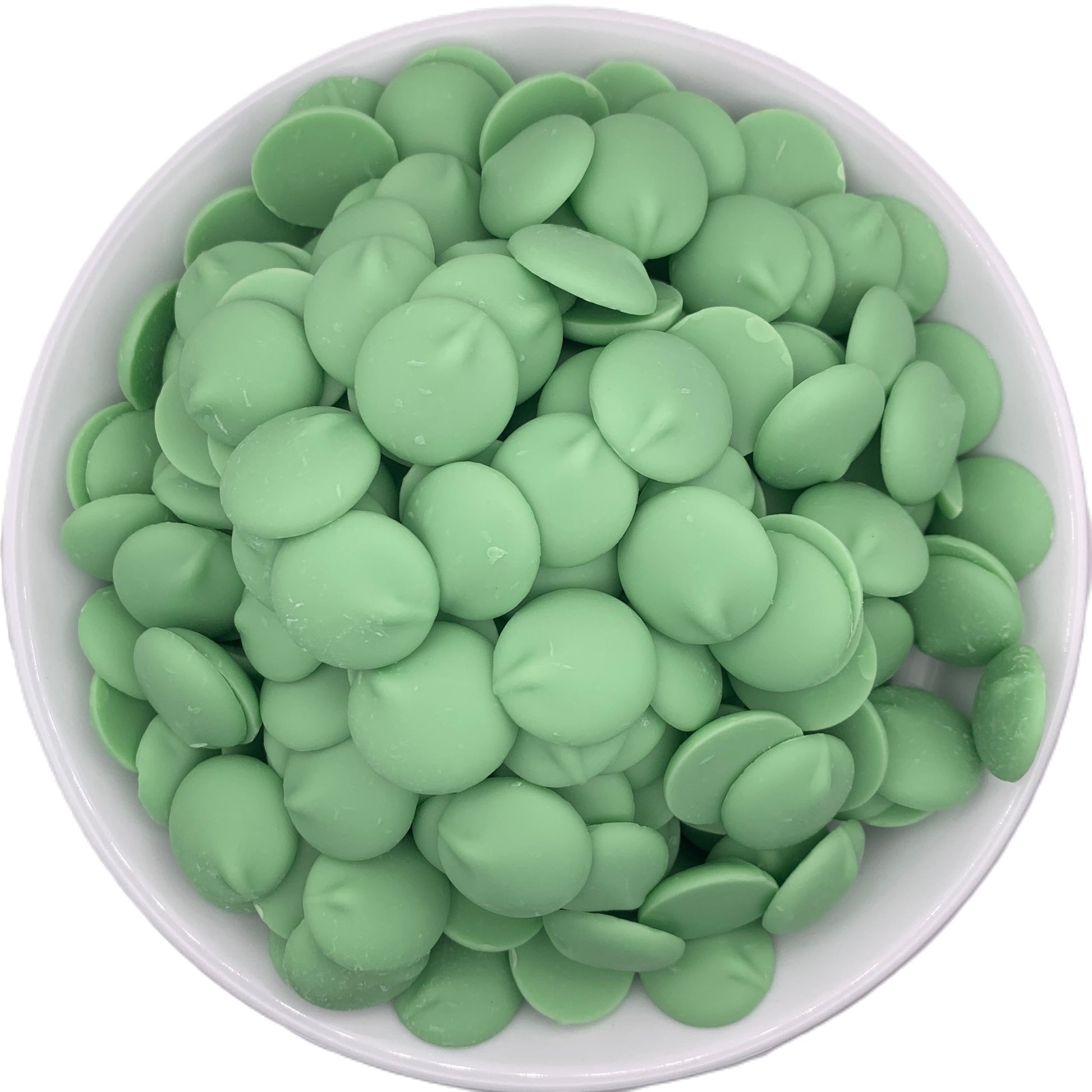 Top view of a white bowl filled with Merckens green chocolate melting wafers, the glossy green wafers neatly packed and ideal for custom candy making.
