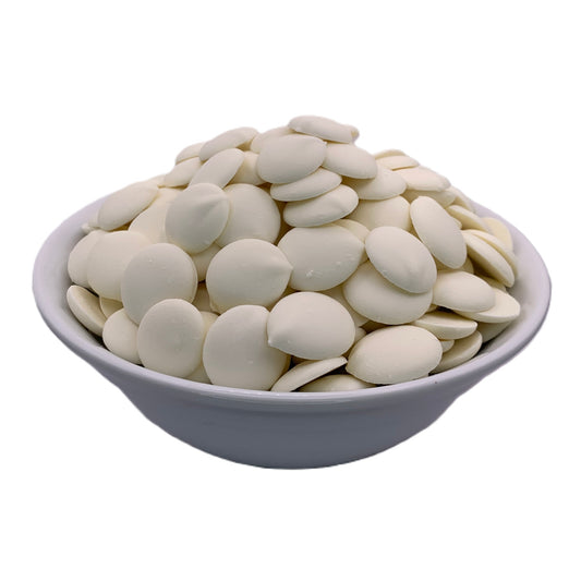 A white bowl filled with Merckens Super White chocolate melting wafers, displayed from the front, highlighting their uniquely bright white color for standout candy creations.