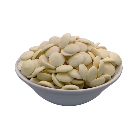 Front perspective of a bowl overflowing with Merckens white chocolate melting wafers, featuring a pristine white color, perfect for dipping and decorating confections.