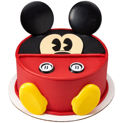 Round cake decorated with Mickey Mouse DecoSet, featuring his signature red outfit, yellow shoes, and black ears.