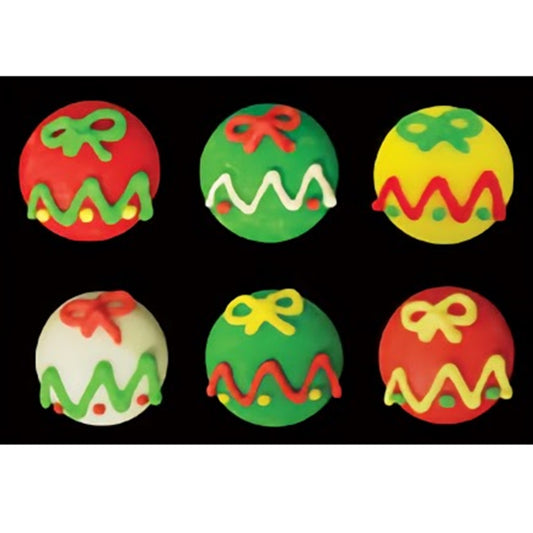 Six assorted royal icing toppers resembling Christmas ornaments, in red, green, and yellow with decorative icing in the shape of ribbons and zigzag patterns.