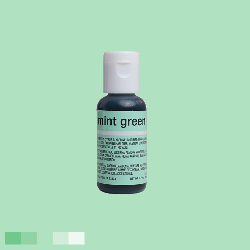 The bottle, topped with a white cap, holds a light green coloring. "mint green" is printed in white on the label, which includes ingredient information in white lettering.