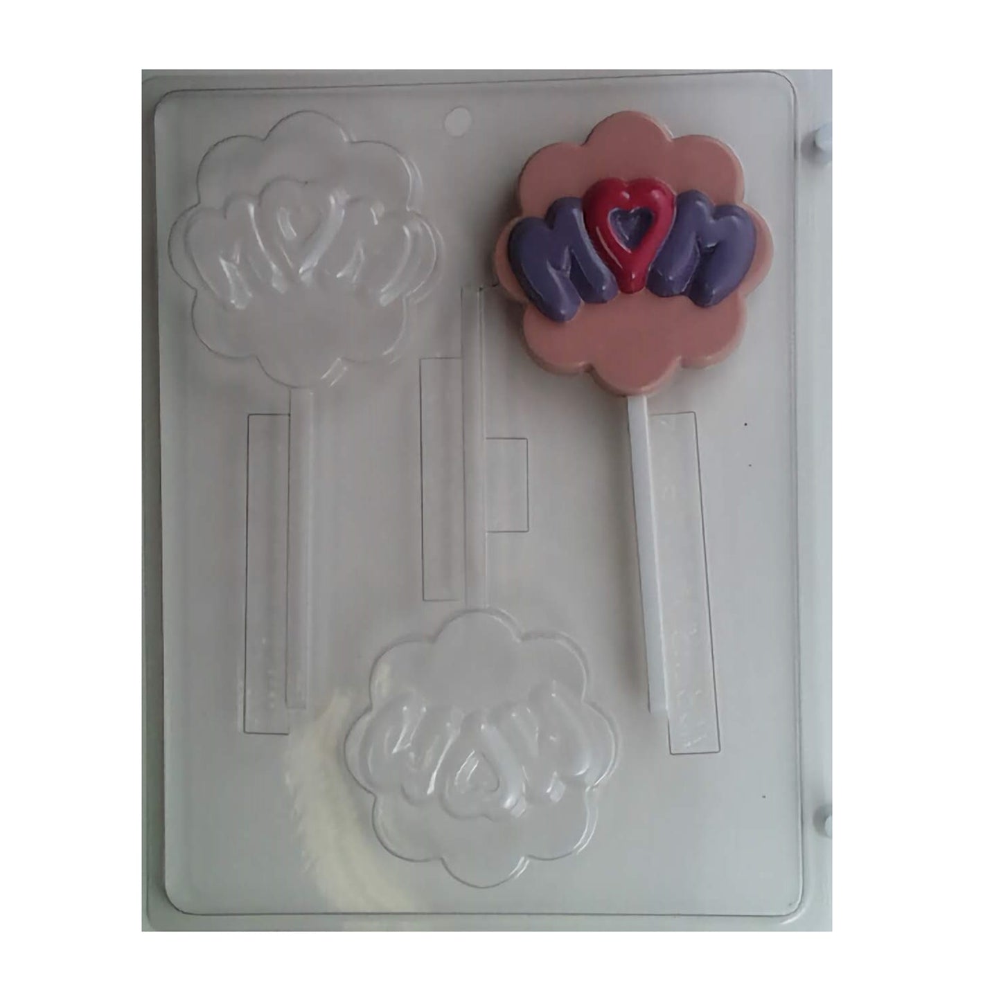 This chocolate mold is designed to celebrate motherhood, featuring two cavities with the word 'Mom' in the center, surrounded by a round scalloped edge. Each cavity includes a stick insert for making lollipops.