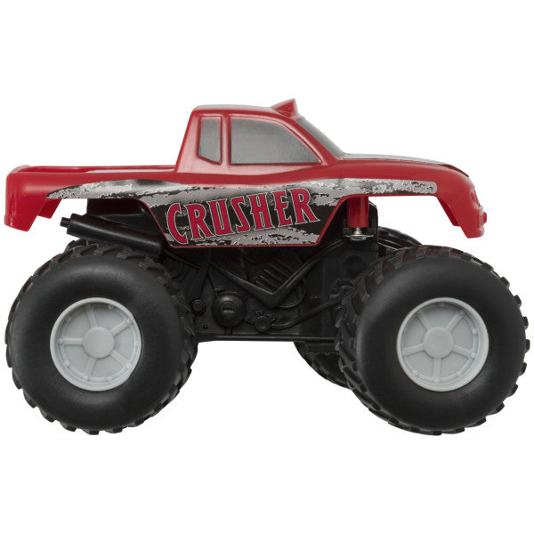 A red and black monster truck toy with "Crusher" printed on the side, designed as a cake topper.