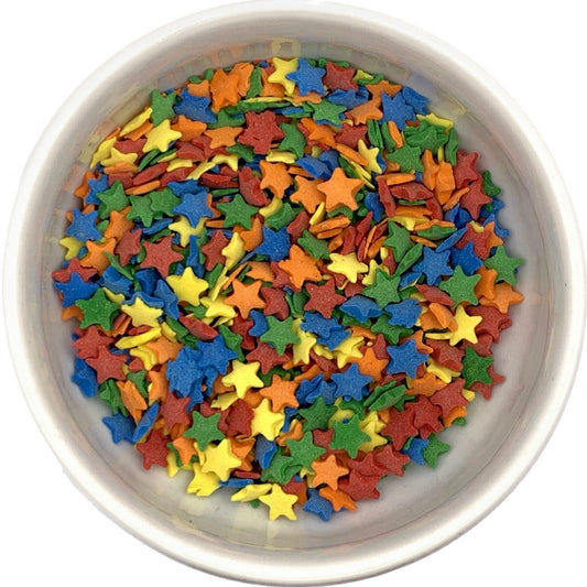 Top-down view of a bowl filled with multicolored star-shaped sprinkles in red, blue, green, yellow, and orange, used for decorating baked goods.